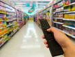© kowitstockphoto - Tv remote control. supermarket in blurry for background