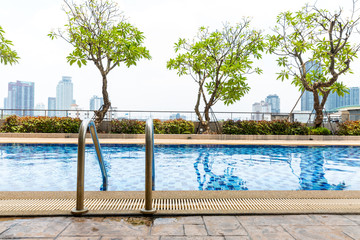 Handrails at border of swimming pool with wavy water