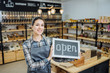 © Iryna - Small business: Happy owner of a cafe showing open sign
