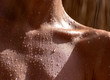 drops of sweat on tanned skin, close-up