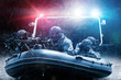 © andy_gin - Group of military fighters on a boat with a flasher are chasing pirates. The concept of sea robberies, piracy, poaching.