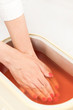© lester120 - Process paraffin treatment of female hands in beauty salon