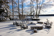 Beautiful Midwest snowy winter nature background. Scenic rural view with covered by fresh snow backyard of the private house with outdoor furniture. Wisconsin countryside, Wausau area.