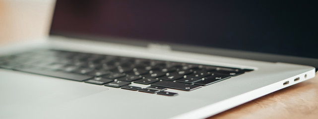 New Apple Macbook Pro on the wooden close up background banner.