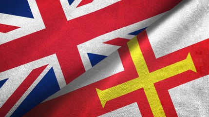 United Kingdom and Guernsey two flags textile cloth, fabric texture