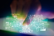 © ra2 studio - Finger touching tablet with web technology icons and DIGITAL CURRENCY inscription