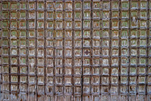 Old Wooden Gate Studded With Slats. Fragment. Old Paint Cracked. Can Be Used As Background Or Texture. Close-up