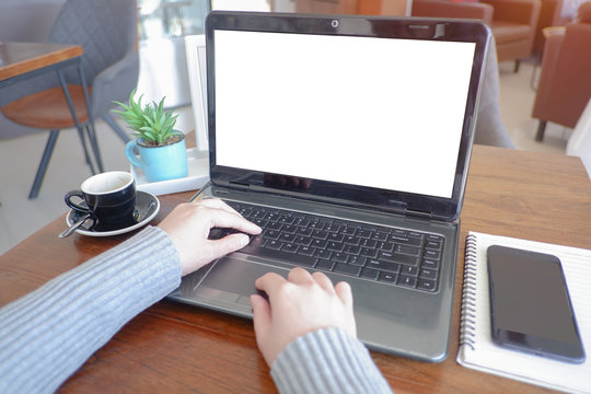 Cropped shot view of business woman’s hands typing the labtop with blank copy space screen for your information content or text message.