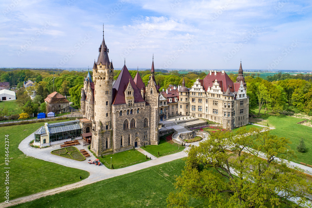 Fabulous historic castle in Moszna near Opole, Silesia, Poland. Built in XVII century, extended from 1900 to 1914. One of the best known and most beautiful monuments in Upper Silesia. Aerial view - obrazy, fototapety, plakaty 