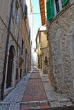 Fototapeta Panele - Veroli, Italy, 01/03/2020. A narrow street between the old houses of a medieval village