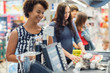 © Nejron Photo - Black woman buying goods in a grocery store