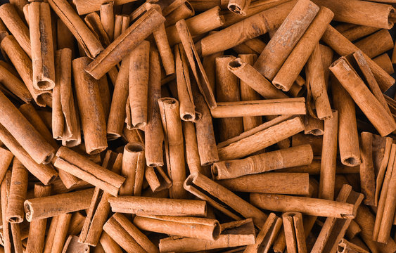 cinnamon background. pile of cinnamons stick top view.