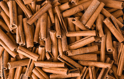 Cuadros en Lienzo Cinnamon background. Pile of cinnamons stick top view.