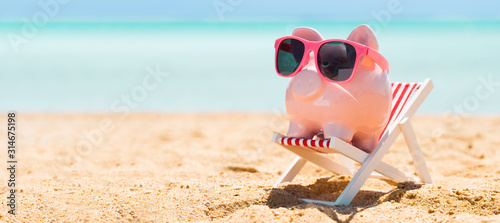 Cuadros en Lienzo Pink Piggybank On Deck Chair Over The Sandy Beach