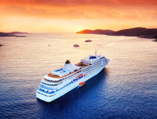 Wall Mural - aerial view at the cruise ship during sunset. adventure and travel. landscape with cruise liner on a
