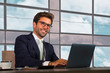 © TheVisualsYouNeed - corporate business portrait of young happy and attractive latin businessman in suit and tie working at modern financial company smiling confident as successful executive man