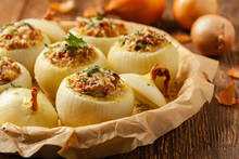 Onion Baked With Cheese Stuffed With Minced Meat. Front View.  Served In Parchment.