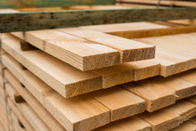 Piles Of Wooden Boards In The Sawmill, Planking. Warehouse For Sawing Boards On A Sawmill Outdoors. Wood Timber Stack Of Wooden Blanks Construction Material. Industry.