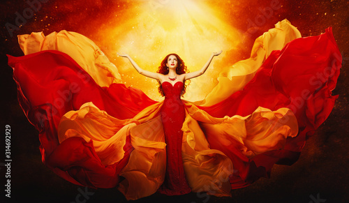 Photographie Woman in Flying Dress Raised Arms to Mystery Light, Fantasy Goddess in Red Flutt