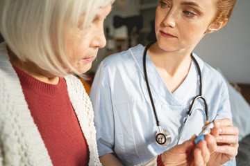 Attentive young female person listening to her patient