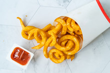 Take Away Curly Fries Ready To Eat With Sauce In Plastic Box Package / Container.