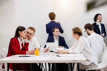 Wall Mural - brainstorm of young successful business people gathered to discuss new business strategies, ideas together in modern office, successful interaction