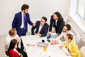 Wall Mural - Young, active people gathered to have discussion, realize creative project together, to have successful interaction. business people concept