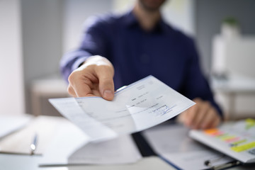 Businessperson Hands Giving Cheque