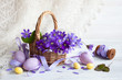 Easter greeting card, spring flowers of anemones in a basket and decorative eggs.