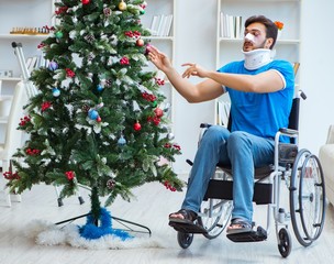 Wall Mural - Injured disabled man celebrating christmas at home