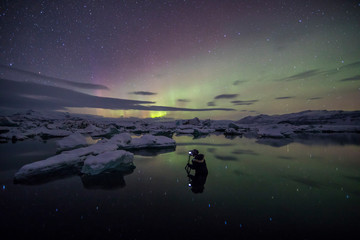 Wall Mural - Aurora Borealis (Northern Lights) above Jokulsarlon Glacier Lagoon with photographer