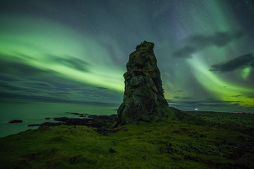 Wall Mural - Aurora Borealis (Northern Lights) above rocks
