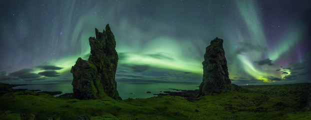 Wall Mural - Aurora Borealis (Northern Lights) above rocks