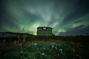 Wall Mural - aurora borealis (northern lights) above a haunted house