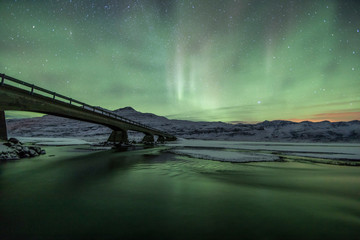Wall Mural - Northern Lights (Aurora Borealis) abovea bridge in the snow