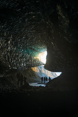 Wall Mural - Explorers in an Ice cave in glacier, Iceland