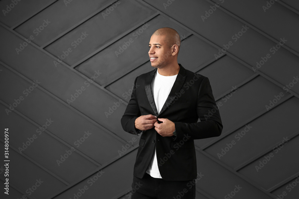 Stylish African-American man on dark background