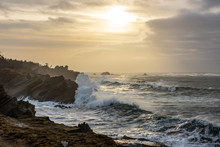 Sunset With Stormy Clouds And Crashing Waves At Shore Acres State Park, Charleston Oregon, USA