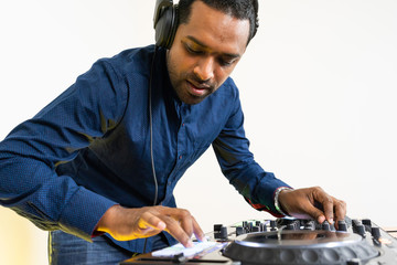 Wall Mural - Male DJ playing music on white background