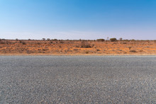 The Road View With Red Dirt At The Background And Blue Sky At Outback Rural Of New South Wales, Australia.