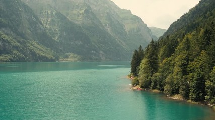 turquoise river water landscape on a sunny day. aerial pan left