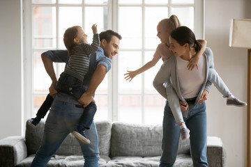 Sticker - Happy kids piggyback parents playing at home together