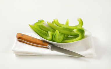 Wall Mural - Green bell pepper slices in bowl