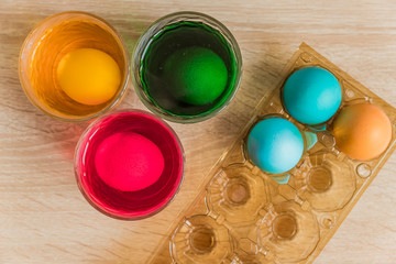 Glass with orange, red and green paint for Easter eggs. Easter Egg decorating.