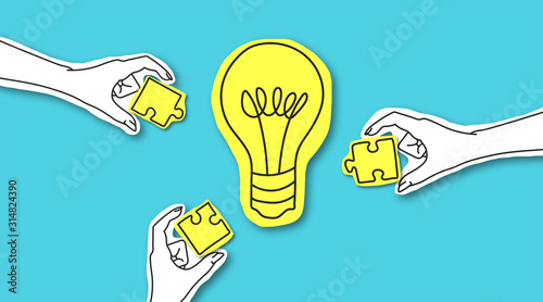 Fotomural Hands with puzzle peaces around glowing light bulb