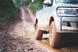  Dirty offroad car, SUV covered with mud on countryside road, Off-road tires,  offroad travel  and driving concept.
