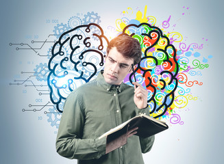 Wall Mural - Thoughtful man with notebook, brain sketch