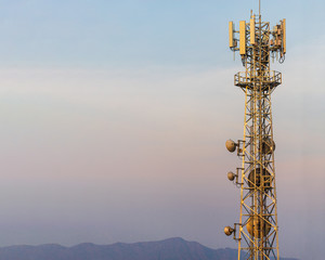 Communication Tower with Parabolic and GSM Antennas on blue sky background with copy space.