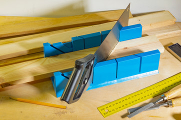 Sawing parts at an angle using a miter box and a hacksaw.