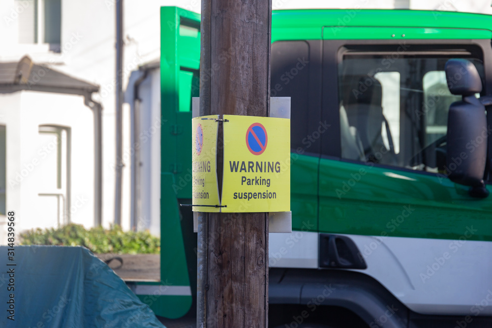 Parking Suspension Warning Sign Board On A Residential London Street parking-suspension-warning-sign-board-on-a-residential-london-street